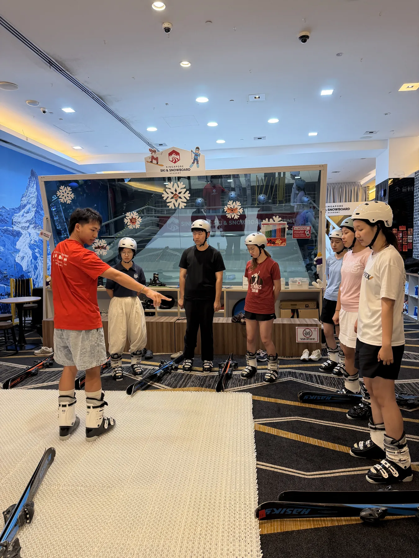 An instructor demonstrating equipment to participants during an indoor training session