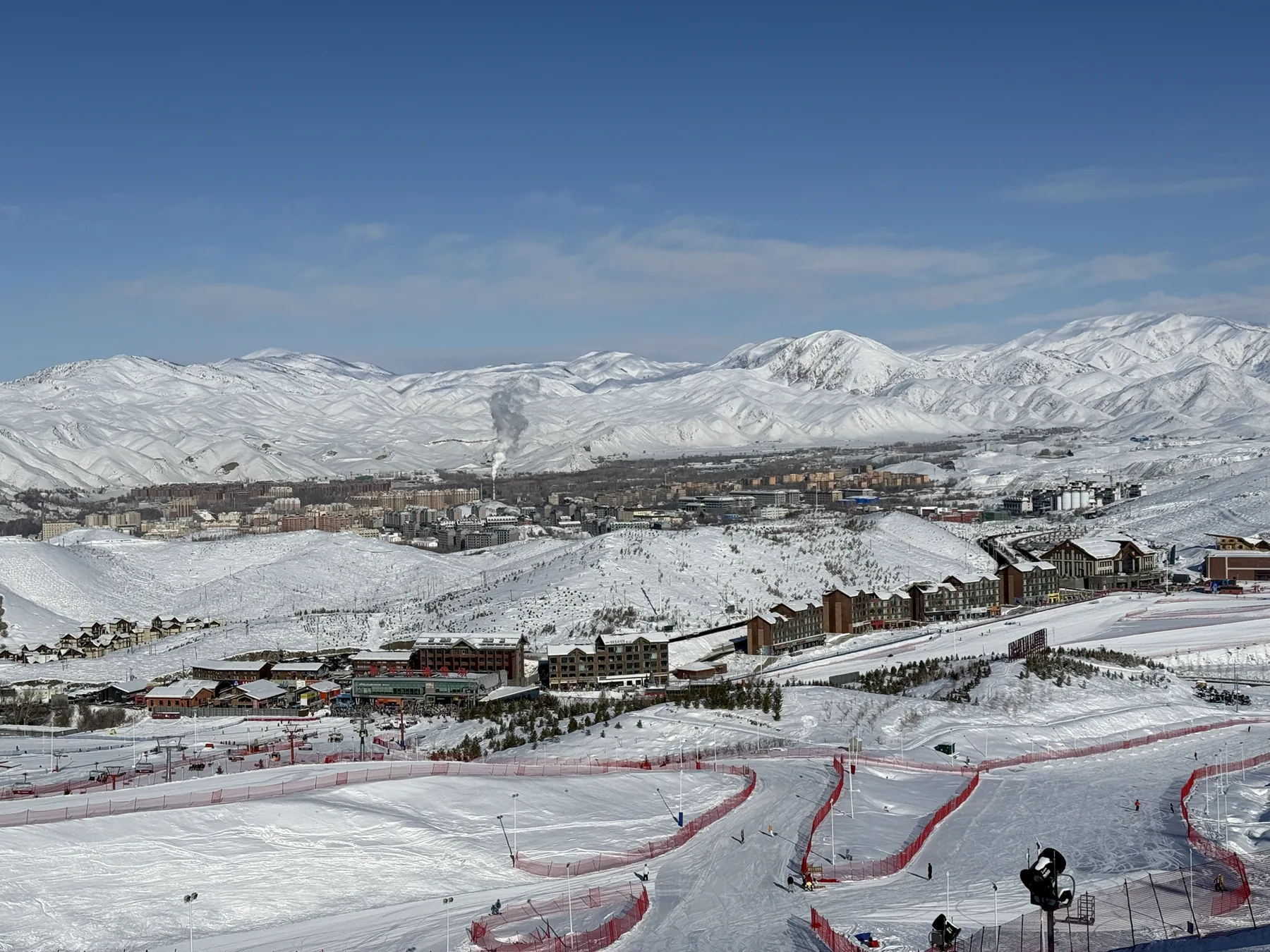Wide view of ski runs and snow-covered mountains in Xinjiang